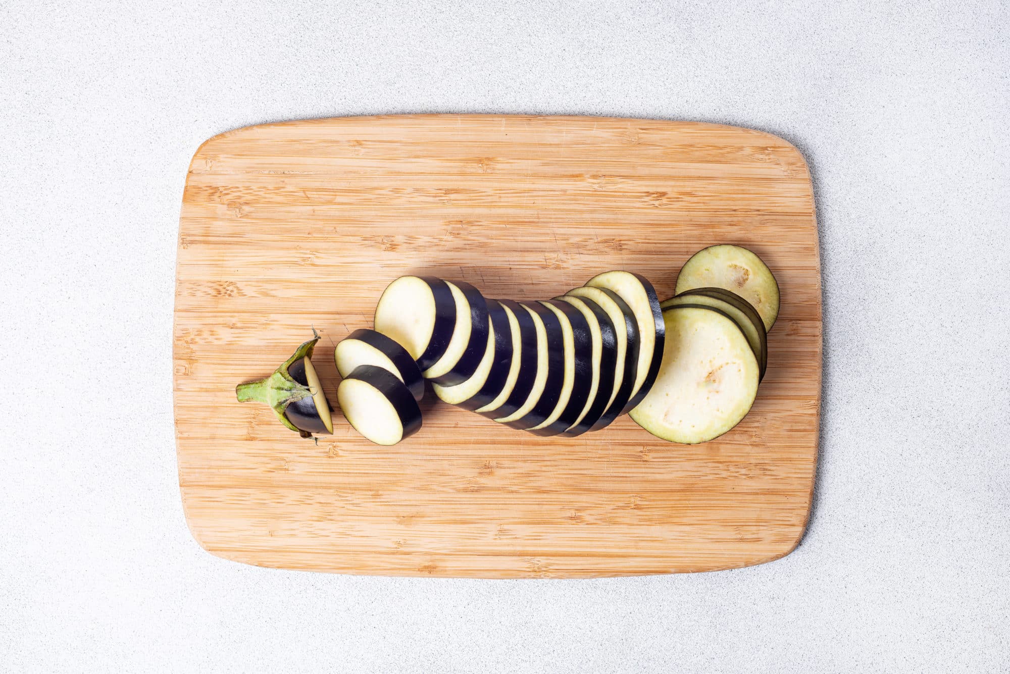 sliced eggplant on a cutting board.