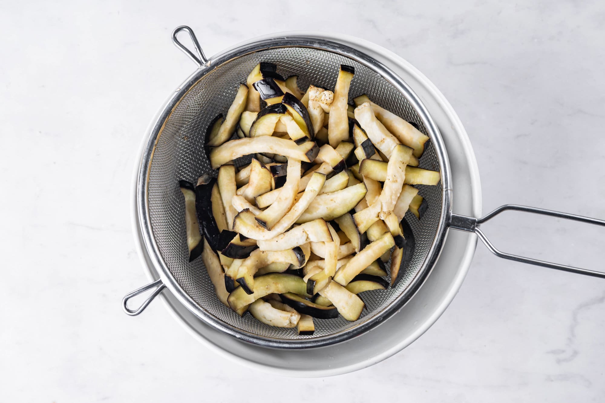 eggplant-chopped-in-colander-in-white-bowl