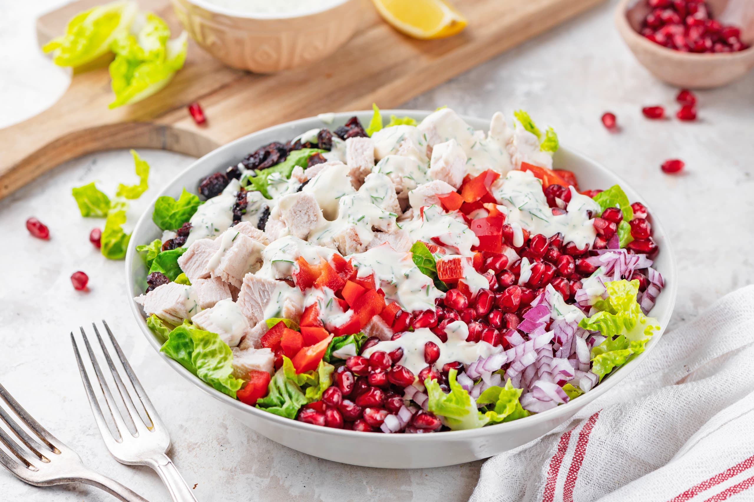Left over turkey salad recipe with dressing in a white bowl.