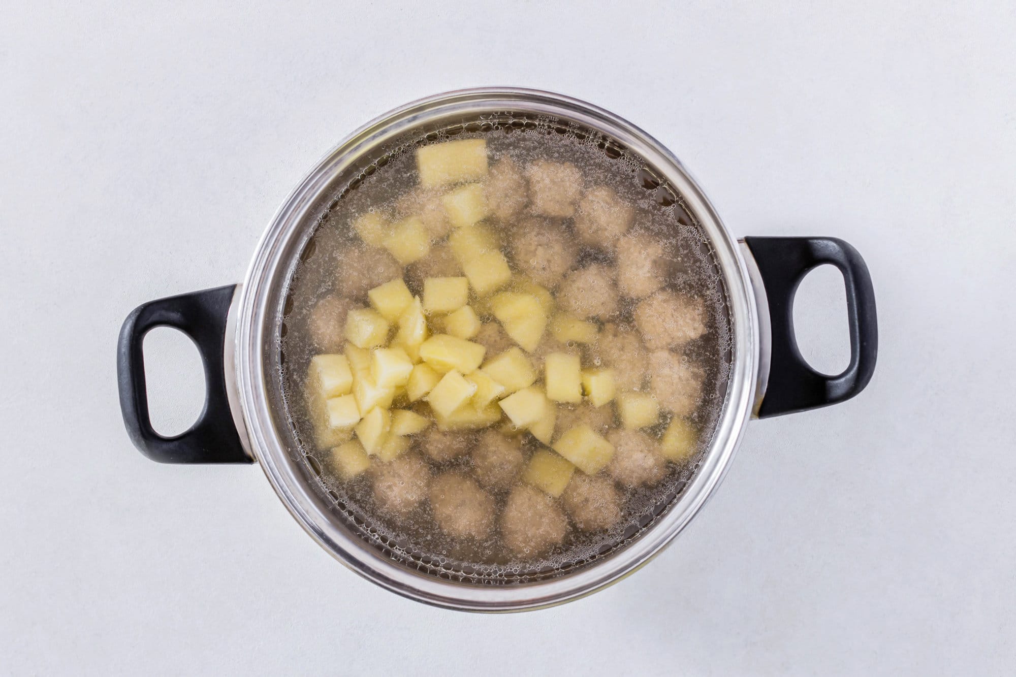 soup-with-meatballs-and-potatoes-in-a-silver-pot