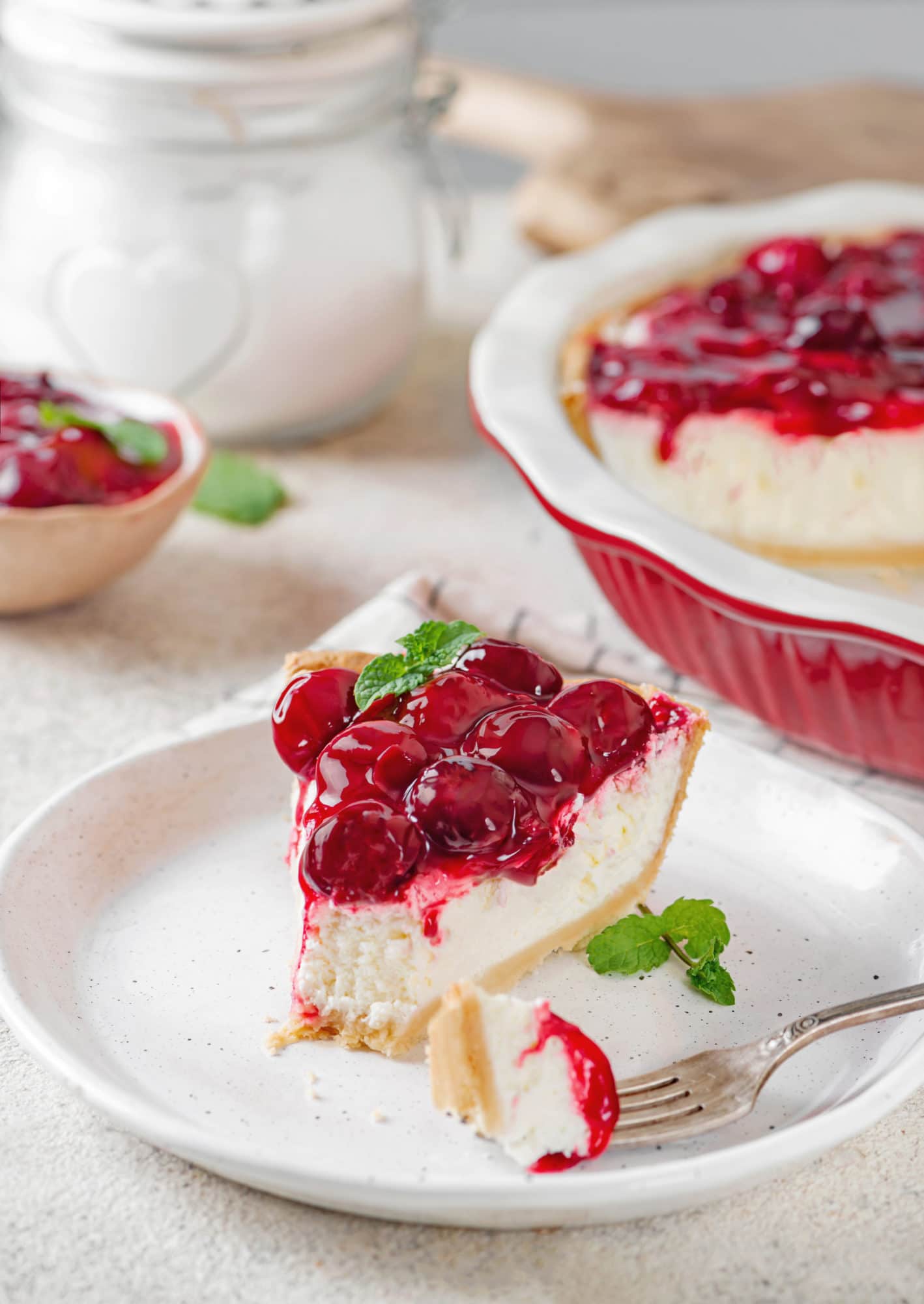 Quick No Bake Perfect Cherry Cheesecake Pie slice of no bake cherry cheesecake on a plate.