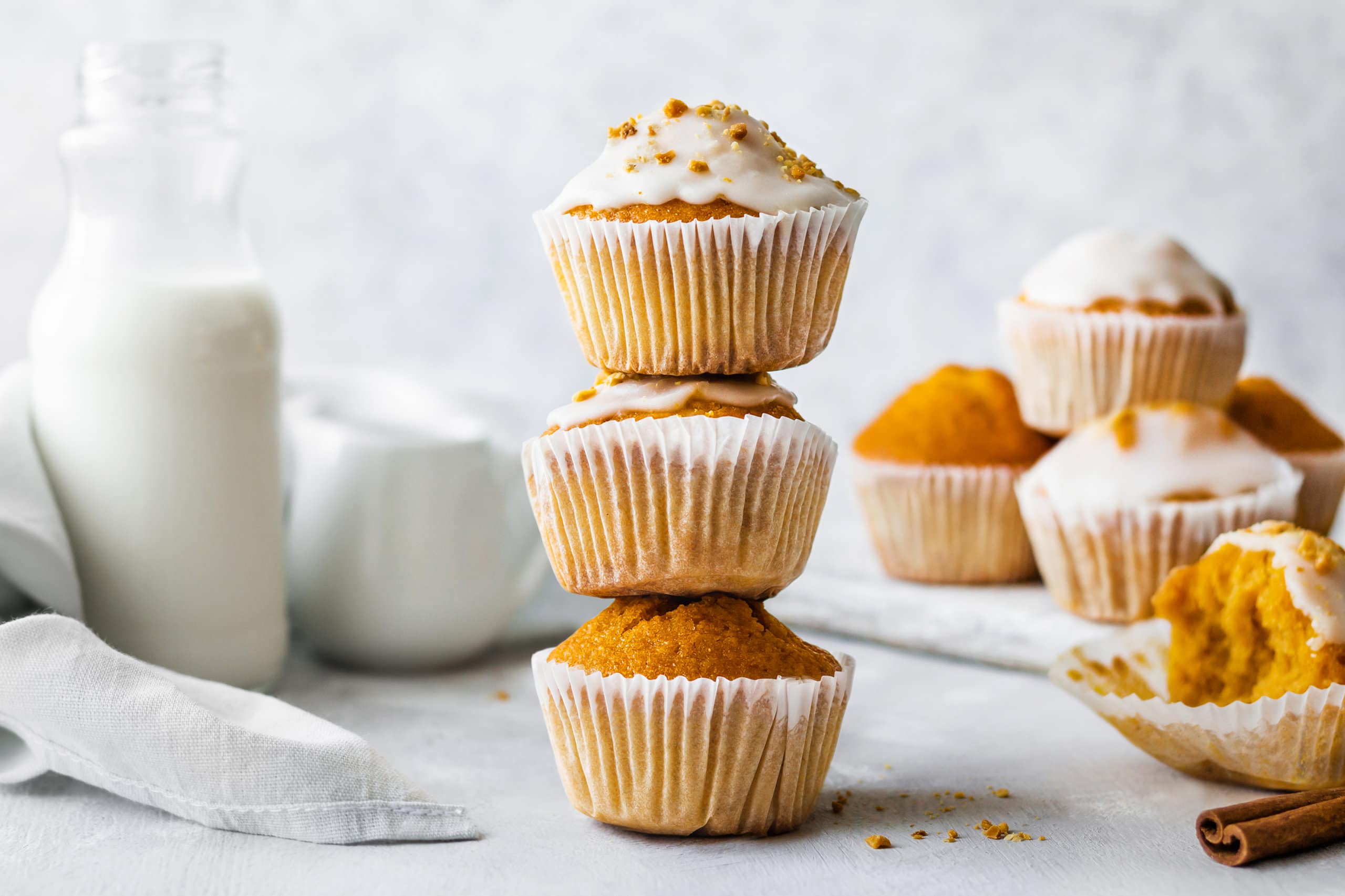 7 Desserts to Eat After Thanksgiving Dinner a stack of pumpkin puffins with glaze on top.
