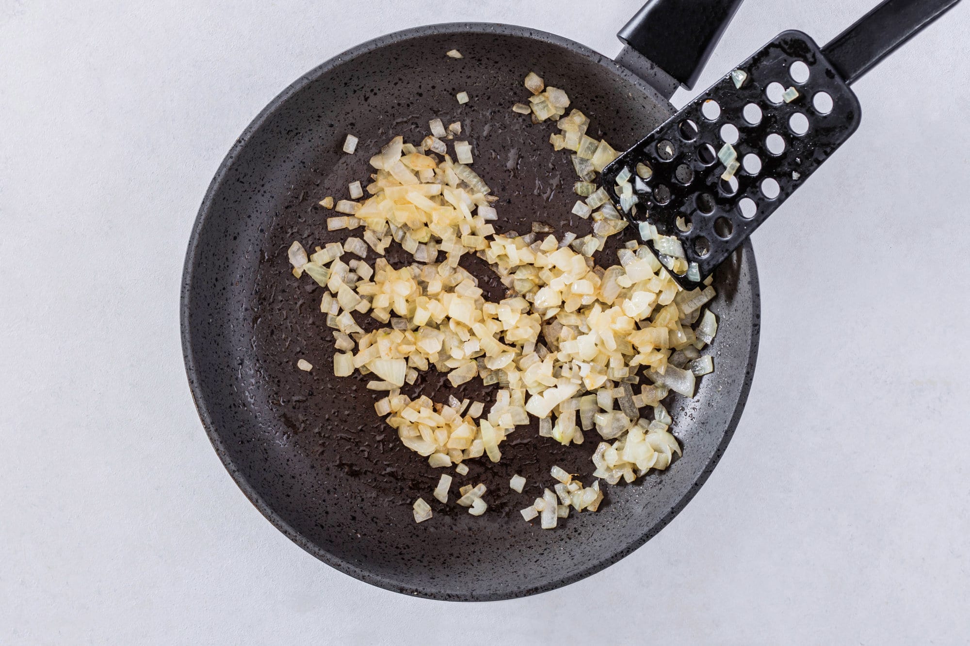 chopped-onion-in-a-skillet-with-a-spatula