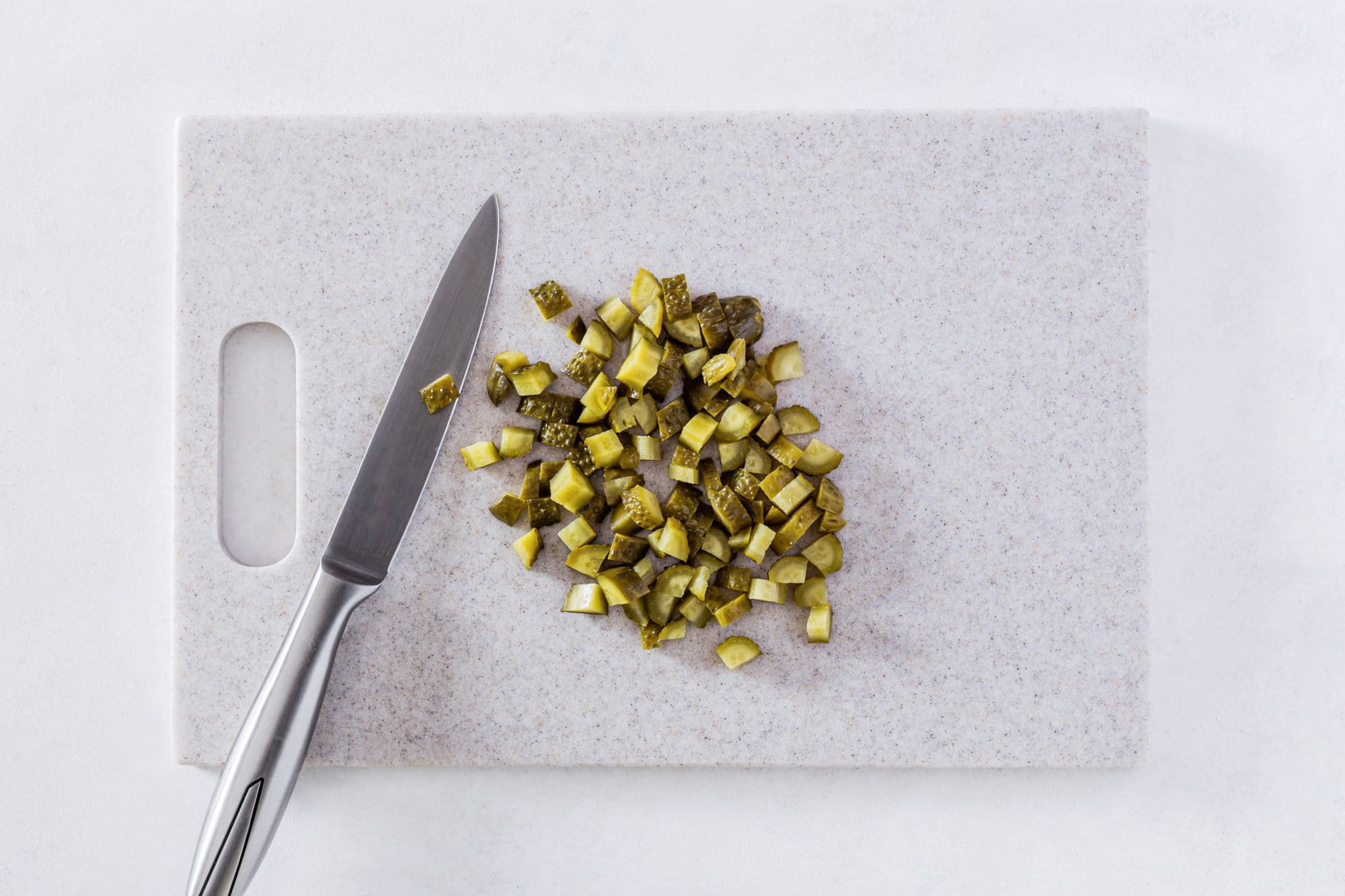 chopped-pickles-on-a-cutting-board-with-a-knife