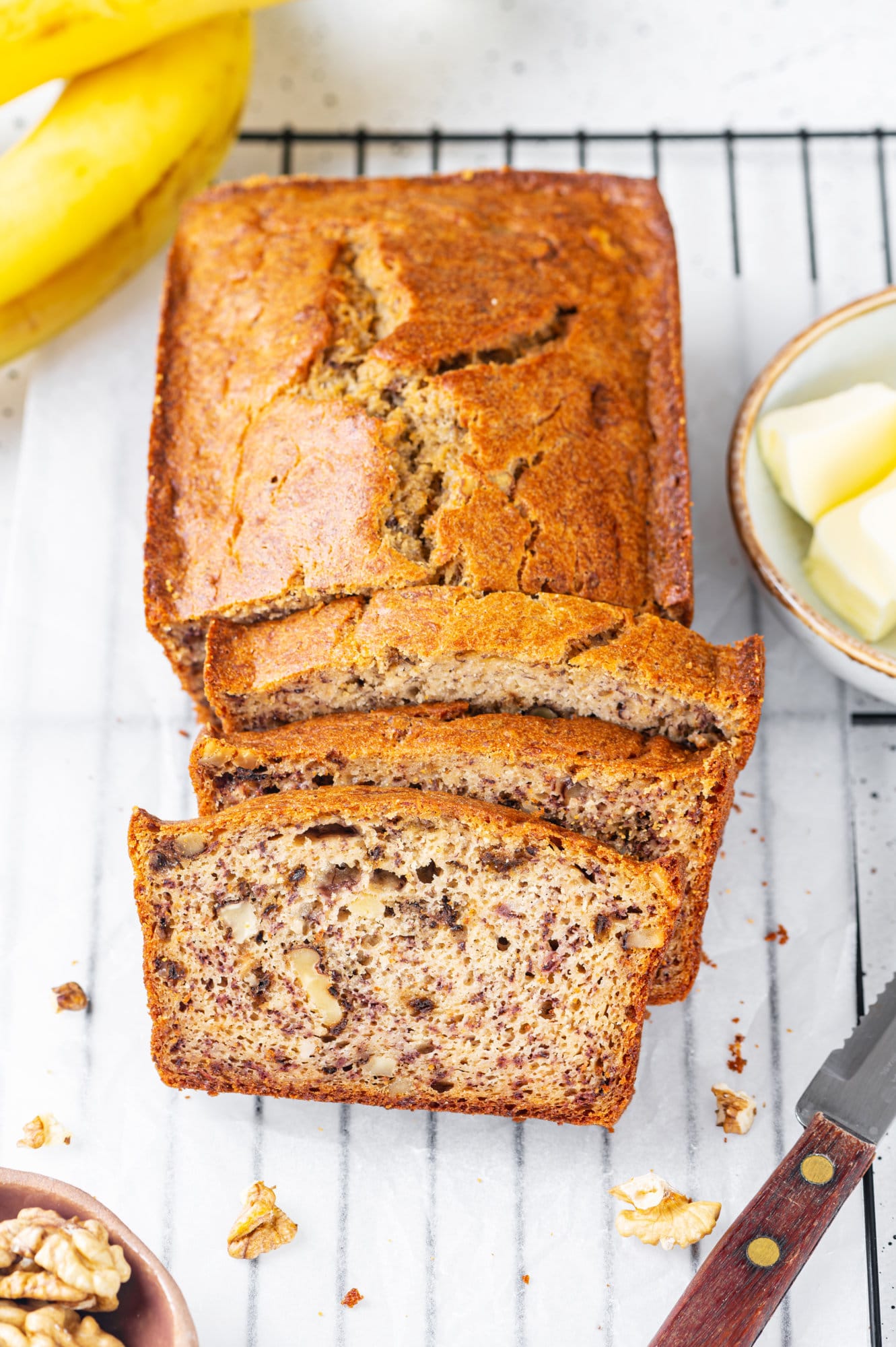 Easy Recipe for Moist Banana Bread Banana bread sliced on a wire rack