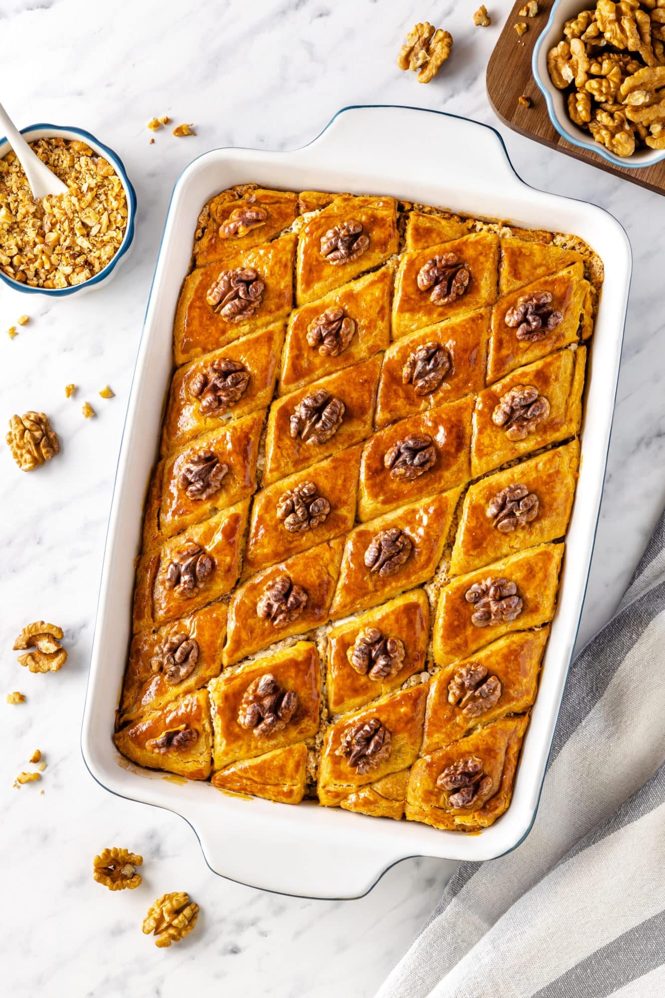 Easy Baklava with a Simple Filling and Walnuts baklava-in-a-baking-tray-with-walnut-pieces-on-top