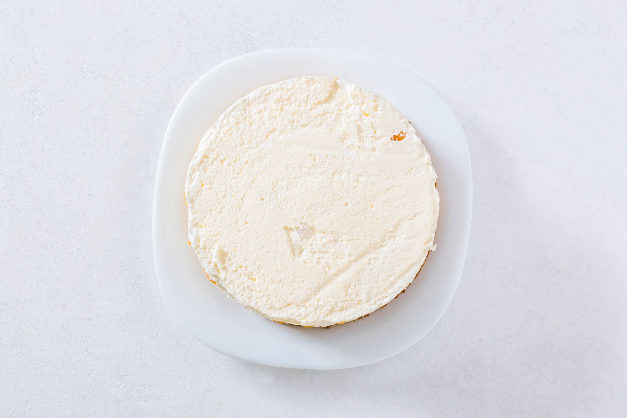 mandarin-orange-mousse-cake-layers-cream-on-a-white-plate
