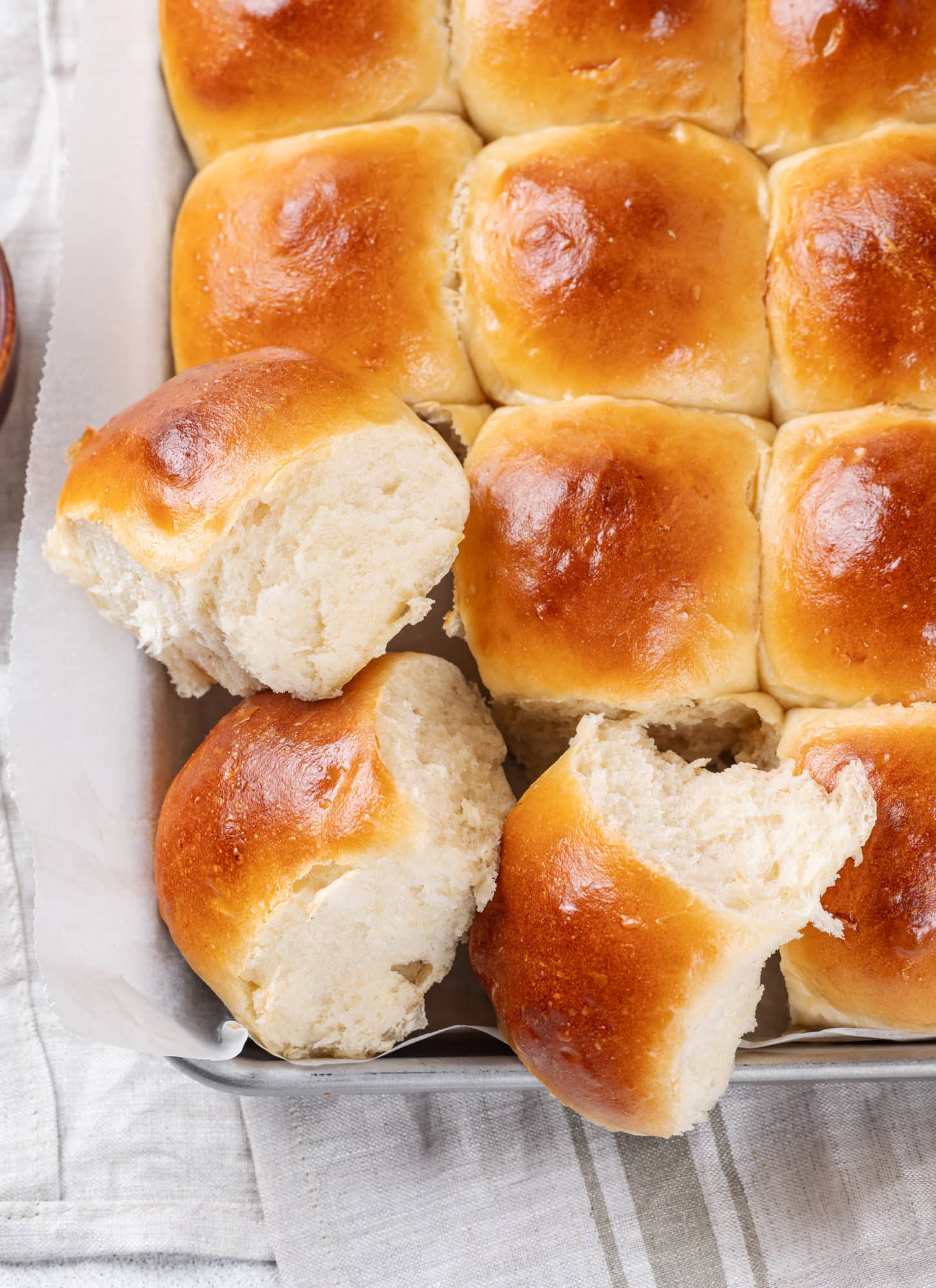 Easy Soft Dinner Rolls Recipe in a Bread Machine dinner-rolls-on-a-baking-shee-with-parchment-paper