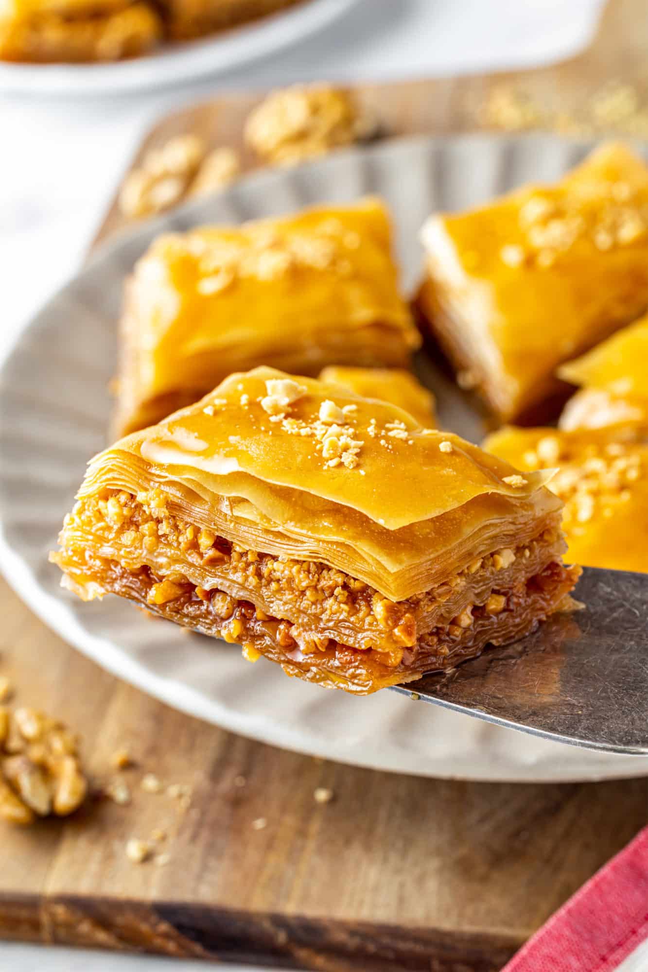 How to make Simple Crunchy Baklava a slice of baklava on a spatula with all the layers revealed.