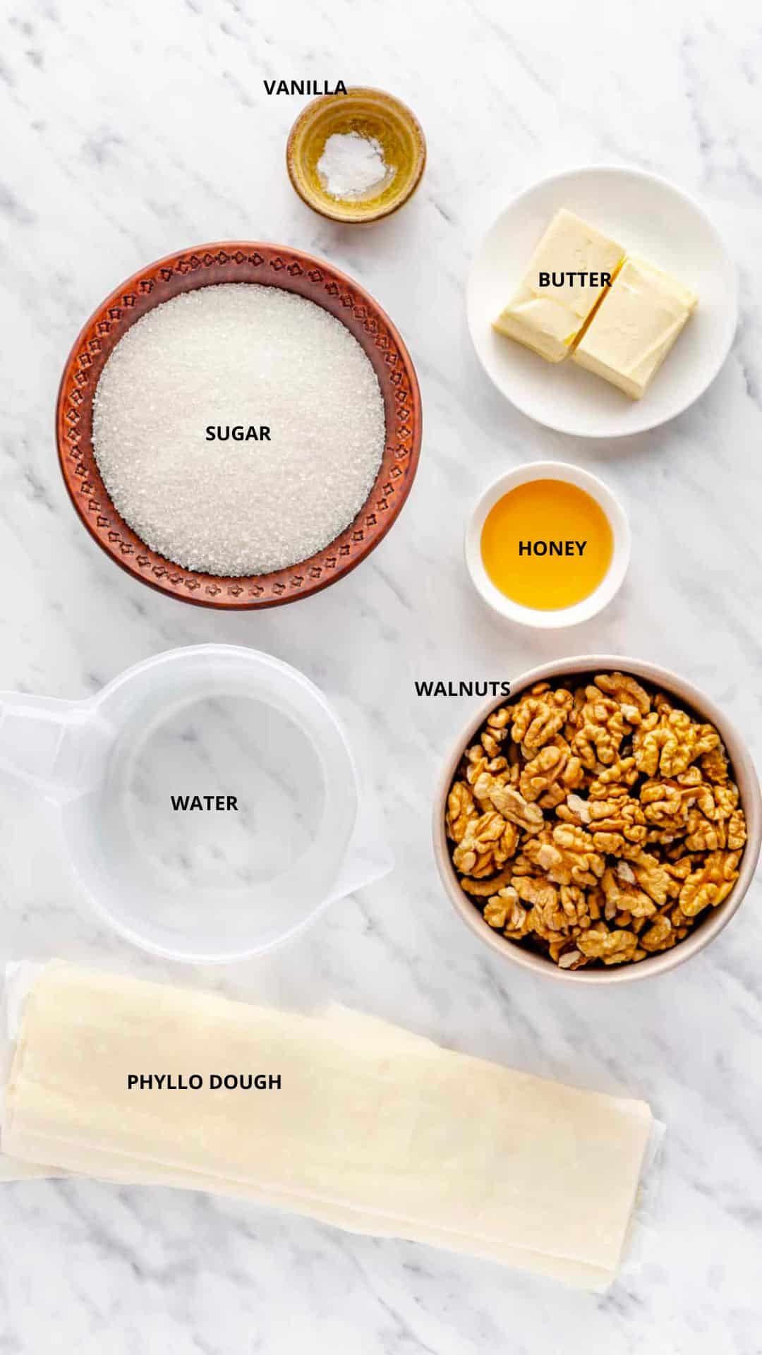 How to make Simple Crunchy Baklava simple crunchy baklava ingredients- butter, vanilla, sugar, honey, walnuts, water, and phyllo dough.